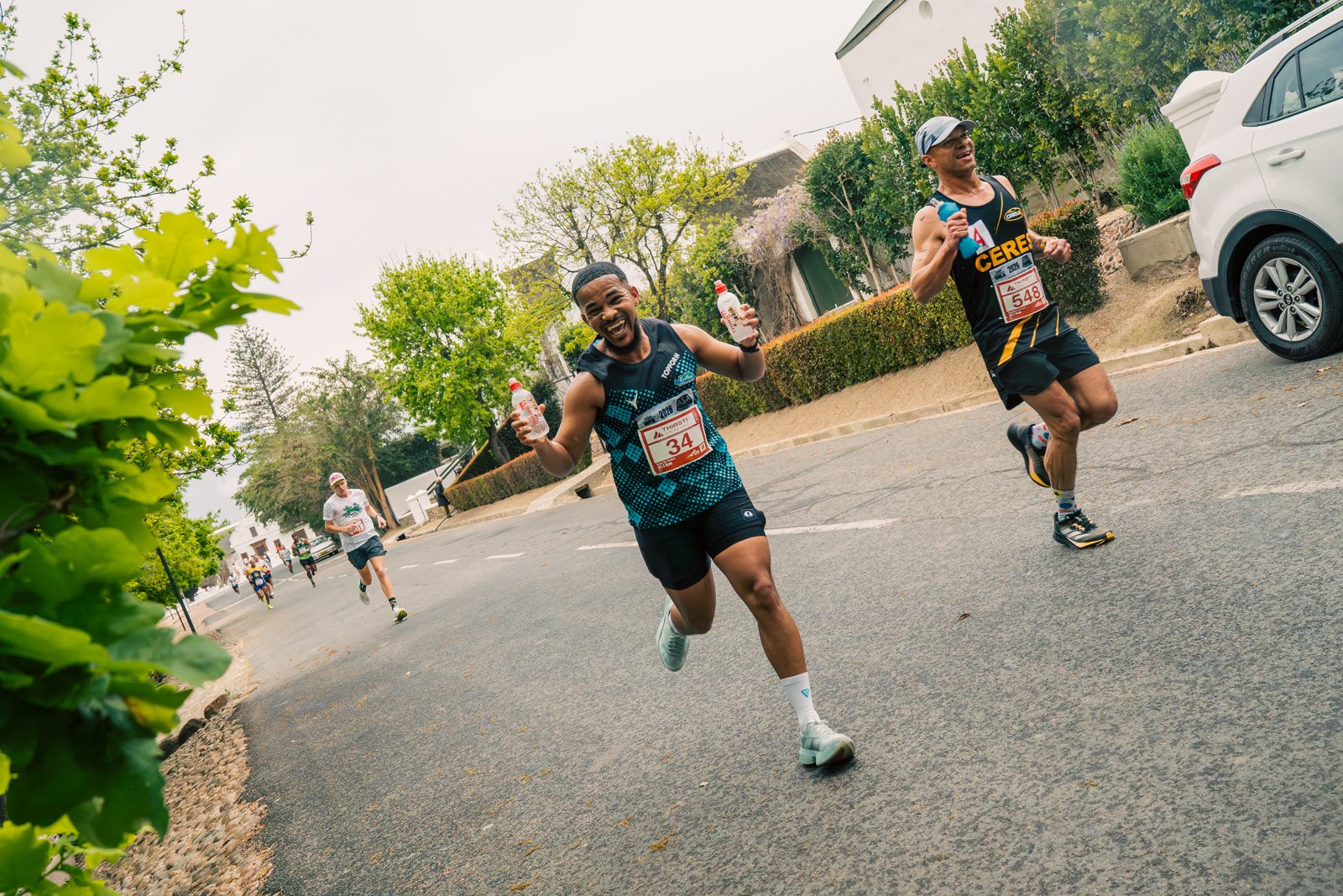 Runners high-fiving during a THIRSTI race